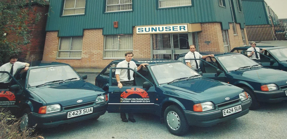 Sunuser team and company vehicles outside the Leeds office in the 1980s